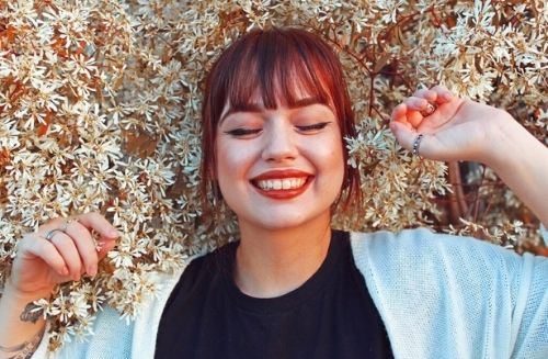 Red headed woman smiling at camera